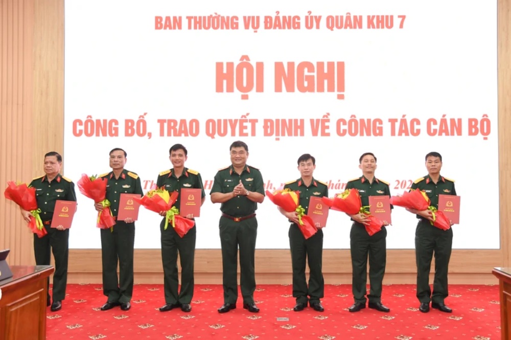 Trung tướng Lê Xuân Thế - Ủy viên Trung ương Đảng, Tư lệnh Quân khu trao quyết định và tặng hoa chúc mừng các cán bộ nhận quyết định. Ảnh: Quân khu 7