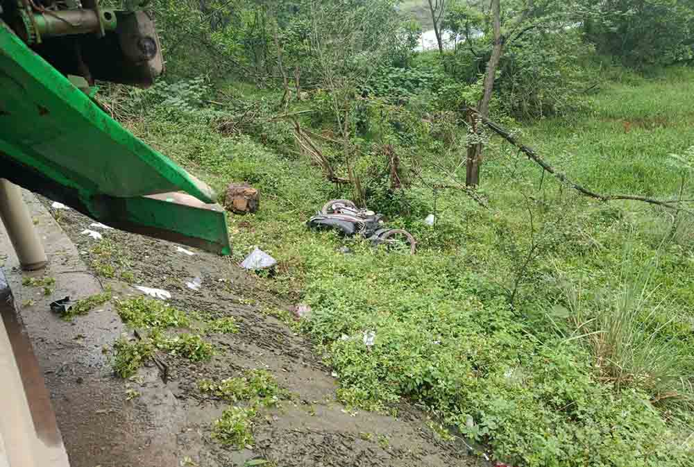 Chiếc xe máy rơi xuống lề đường sau tai nạn. Ảnh: Đức Tuấn