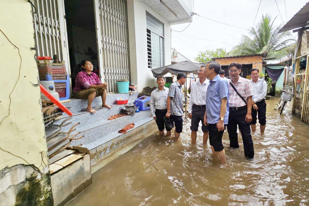 Chủ tịch UBND thành phố Cần Thơ Trương Cảnh Tuyên lội nước vận động người dân bàn giao mặt bằng thuộc dự án nâng cấp, mở rộng Quốc lộ 91 (đoạn Km0 - Km7) năm 2025. Ảnh: Tạ Quang