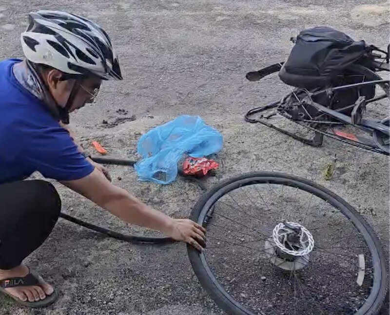 Anh Định tự sửa xe, thay lốp trong suốt hành trình. Ảnh: NVCC