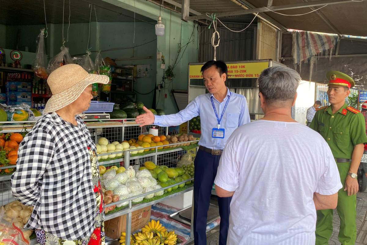 El presidente del Comité Popular del barrio de Phuoc Thang intercambió directamente opiniones y solicitó a la gente que cumpliera estrictamente, sin invadir las aceras. Foto: Thu Trang