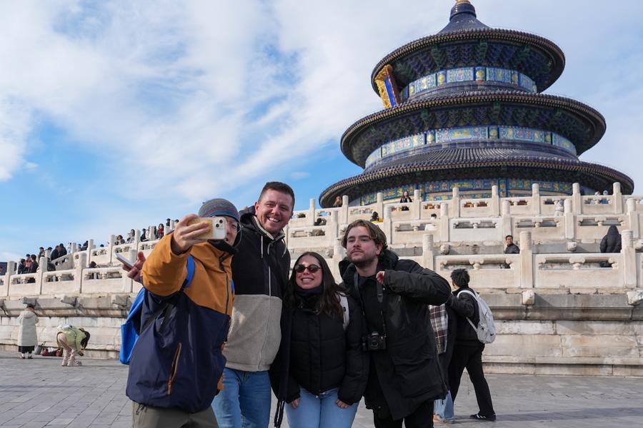 International visitors and tour guides check in at Thien Dan Park in Beijing, China. Photo: Xinhua