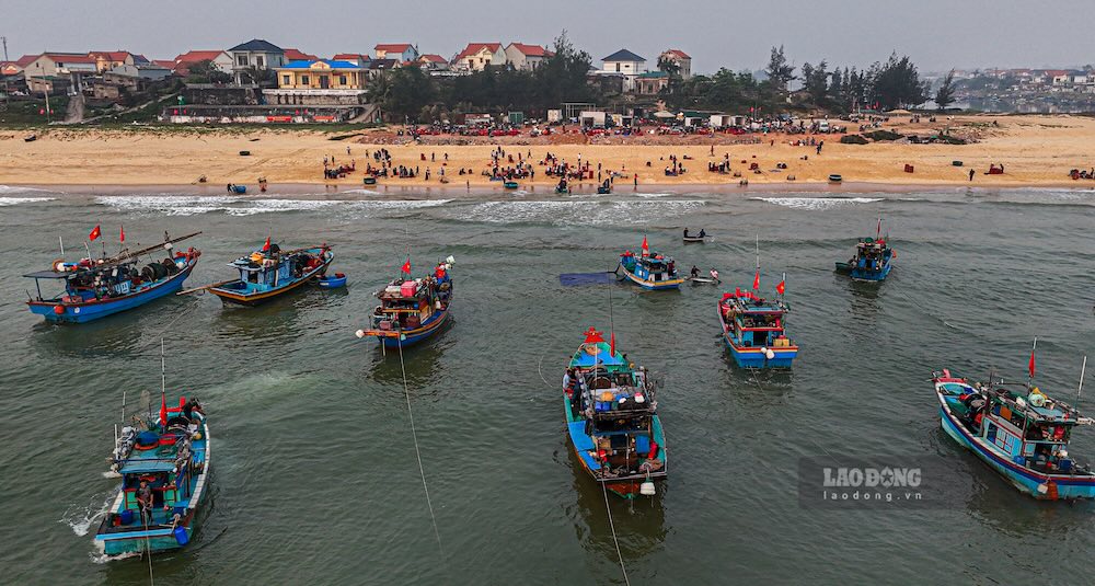 Phía bờ biển, thuyền đánh cá vẫn liên tục vào bờ, mang theo những chiến lợi phẩm. Ảnh: Nguyễn Luân