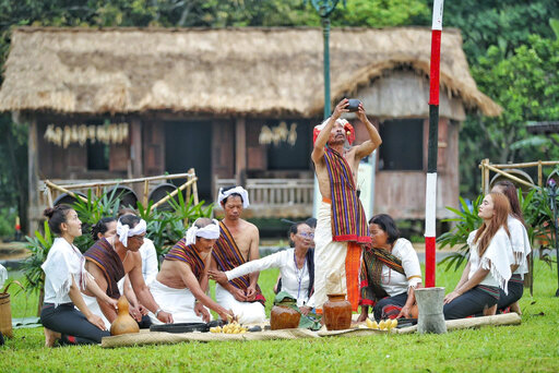 Opening jars of rice wine, connecting the community in the joy of the new season. Photo: Tuan Minh