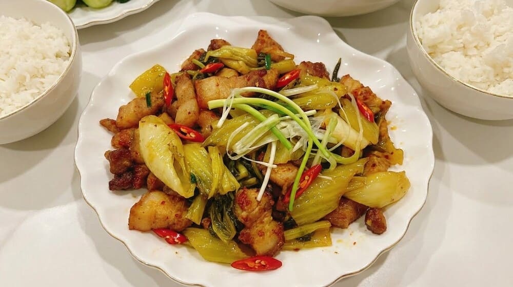 Simple and attractive way to make stir-fried pork belly with pickled mustard greens and bring rice on rainy and windy days. Photo: Tuan Dat