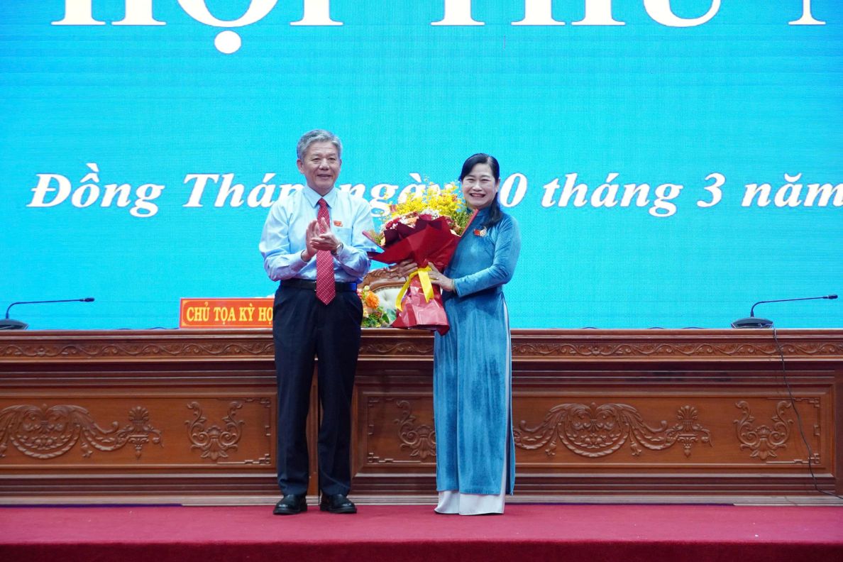 Ông Ngô Chí Cường - Bí thư Tỉnh ủy, Chủ tịch HĐND tỉnh Đồng Tháp khóa XI, tặng hoa cảm ơn, ghi nhận sự đóng góp của bà Châu Thị Mỹ Phương - Chủ tịch HĐND tỉnh Đồng Tháp khóa X. Ảnh: Việt Tiến