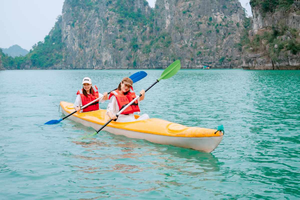 Kayak tourists explore Vung Vieng fishing village. Photo: Chi Long