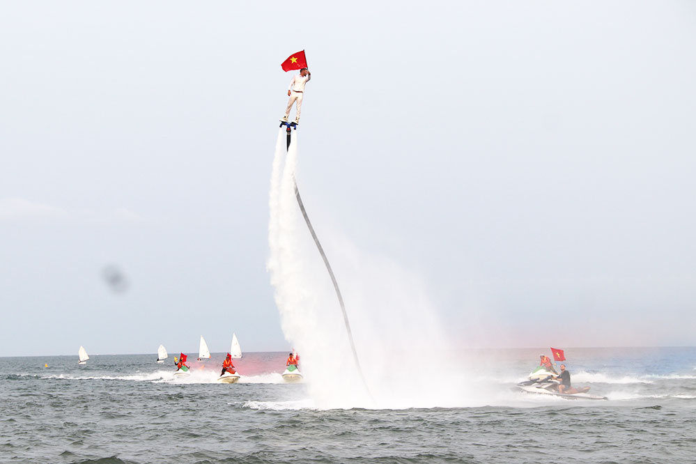 Tourists come to Da Nang beach to watch Flyboard and water motorbike performances. Photo: Tran Thi