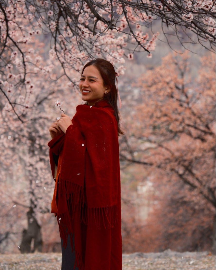 Happiness standing in the middle of the brilliant flower season in Hunza valley, Pakistan. Photo: Huyen Linh