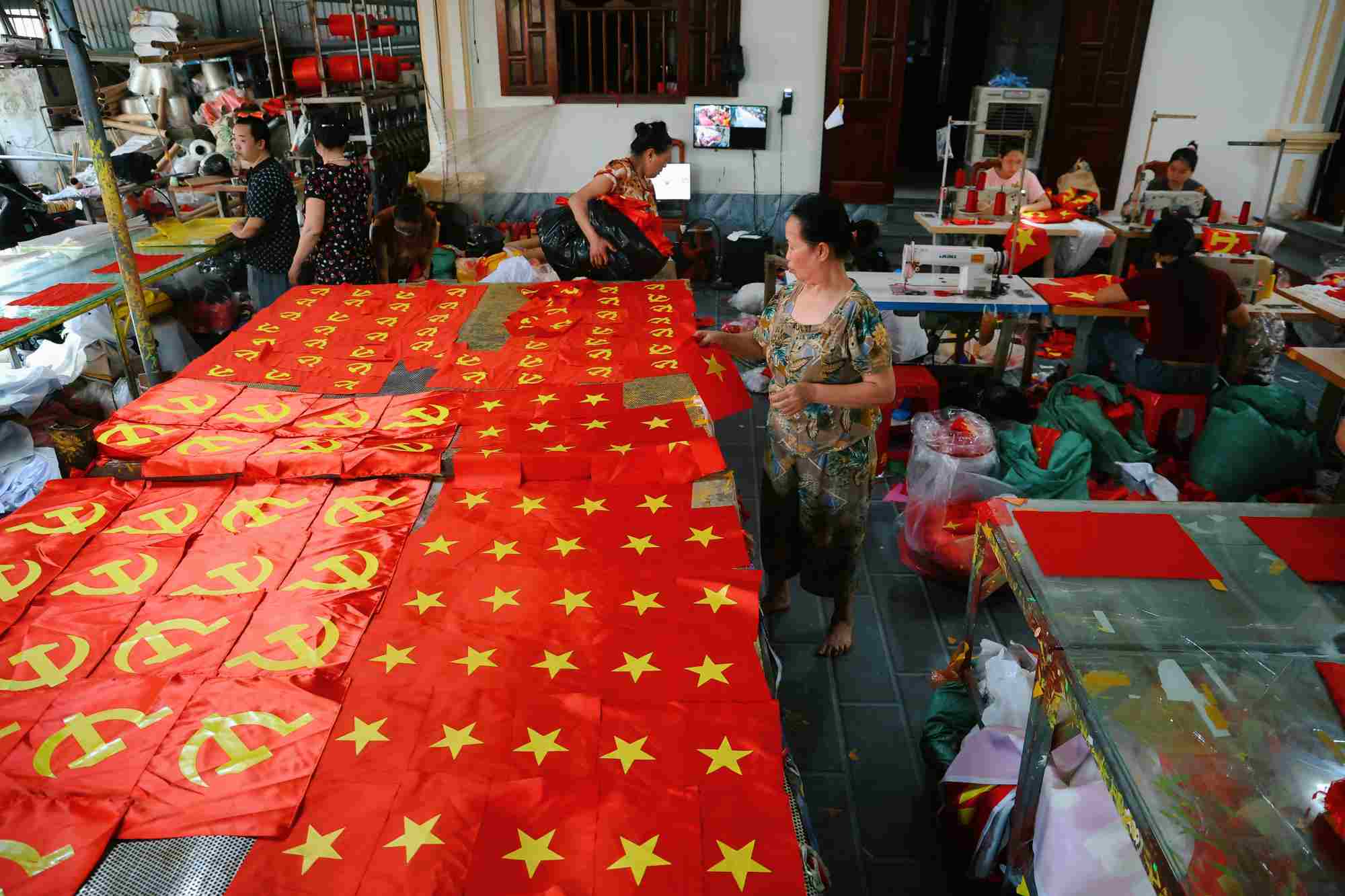 Không khí tại xưởng in luôn tất bật và hối hả để kịp cung ứng cờ Tổ quốc cho người dân cả nước dịp lễ 30.4. Ảnh: VIỆT ANH 