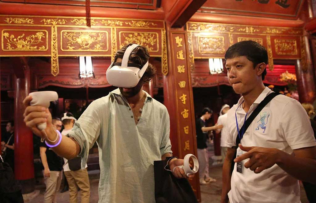 Visitors experience Leap motion technology to explore the content of books at the Temple of Literature - Quoc Tu Giam. Photo: THANH NHAN