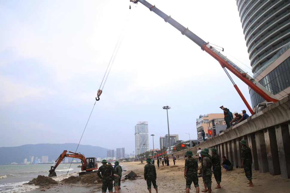 Lực lương quân đội huy động máy móc, nhân lực trục vớt xác xe tăng. Ảnh: Hoài Phương