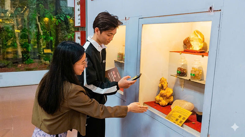  Du khách khám phá thông tin cổ vật bằng  cách quét mã QR. Ảnh: Duy Tuấn