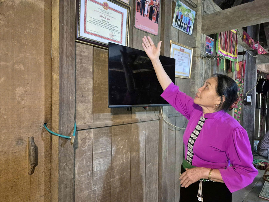 Nghệ nhân Lò Thị Tóm giới thiệu về ngôi nhà sàn người Thái. Ảnh: Trần Hạnh