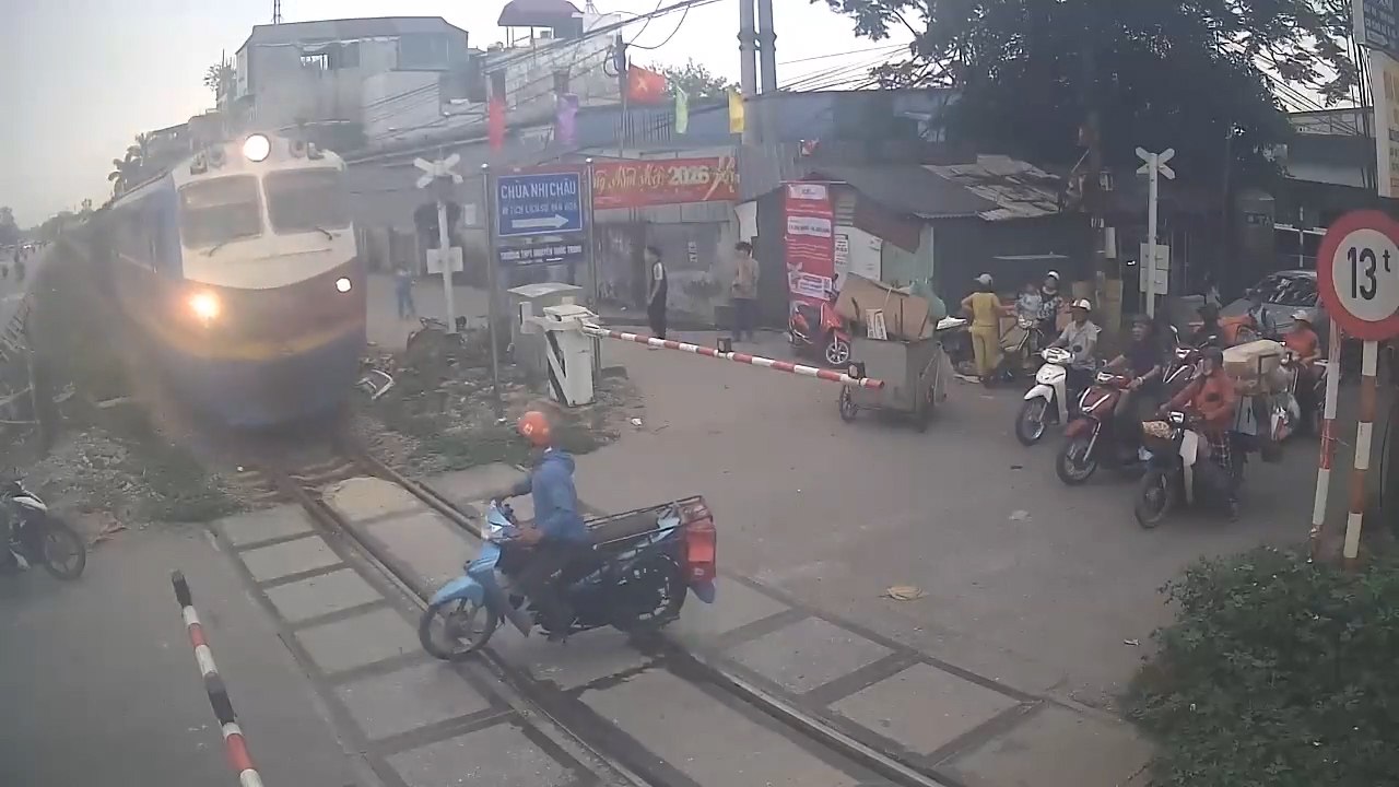 Heart-stopping scene of motorbike driver escaping danger right in front of a train
