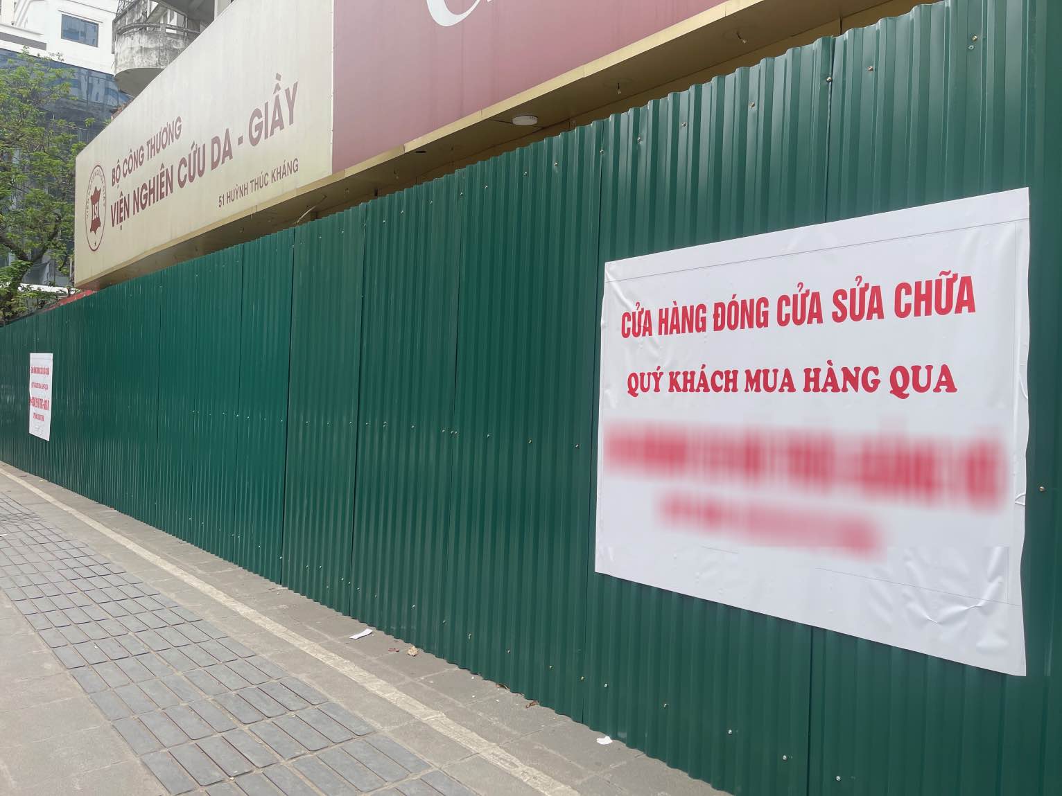 Cửa hàng từng kinh doanh tại khu vực này thông báo thay đổi địa điểm sau khi lực lượng chức năng tiến hành quây tôn khu vực này. Ảnh: Hoài Anh