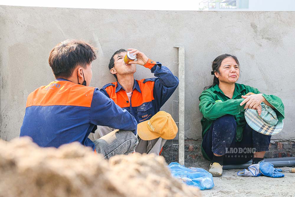 A group of workers take advantage of resting in the harsh weather from the beginning of summer in Hanoi.