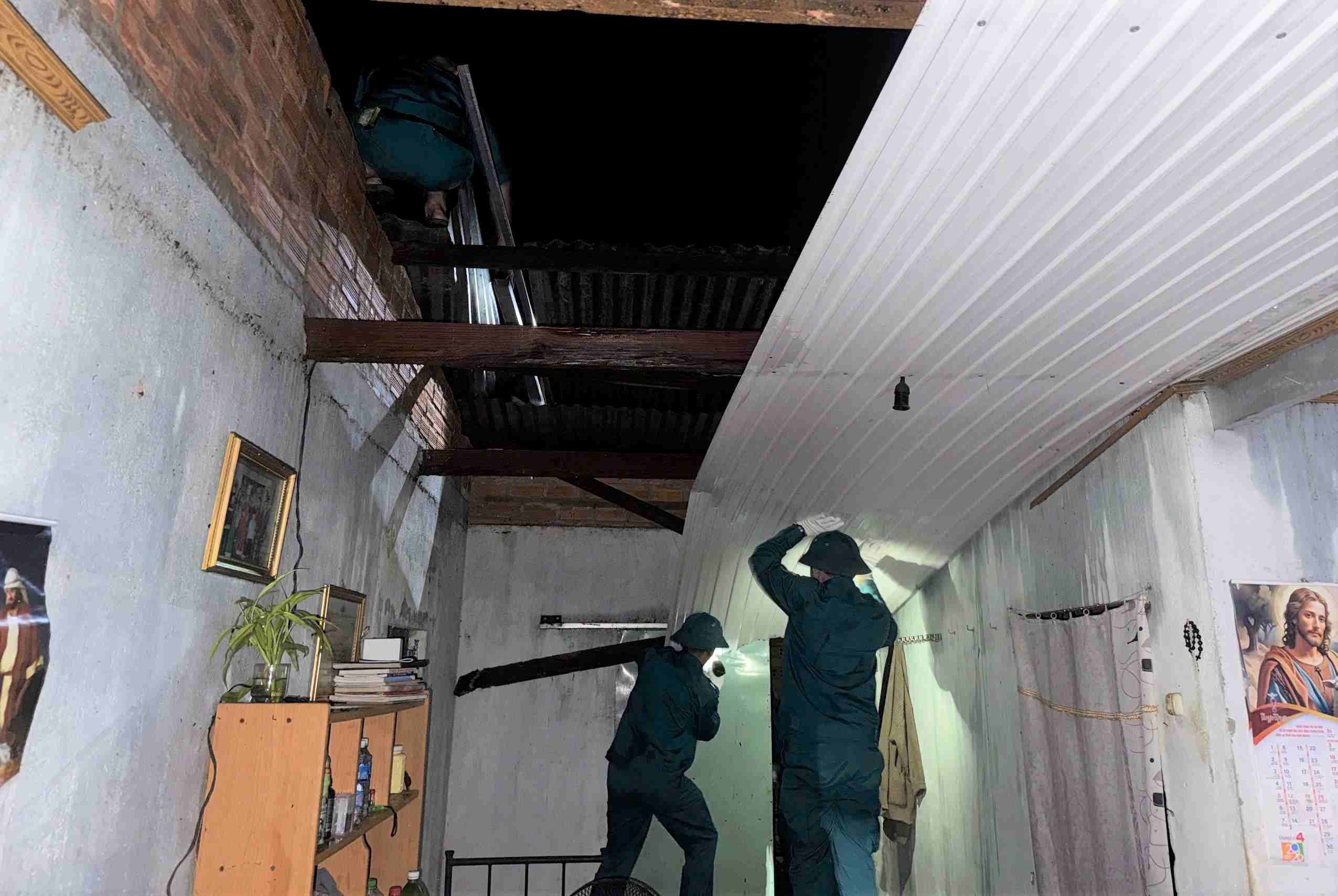 Các lực lượng xã Nhân Cơ hỗ trợ người dân lợp lại mái nhà. Ảnh: Ban Chỉ huy Quân sự xã Nhân Cơ 