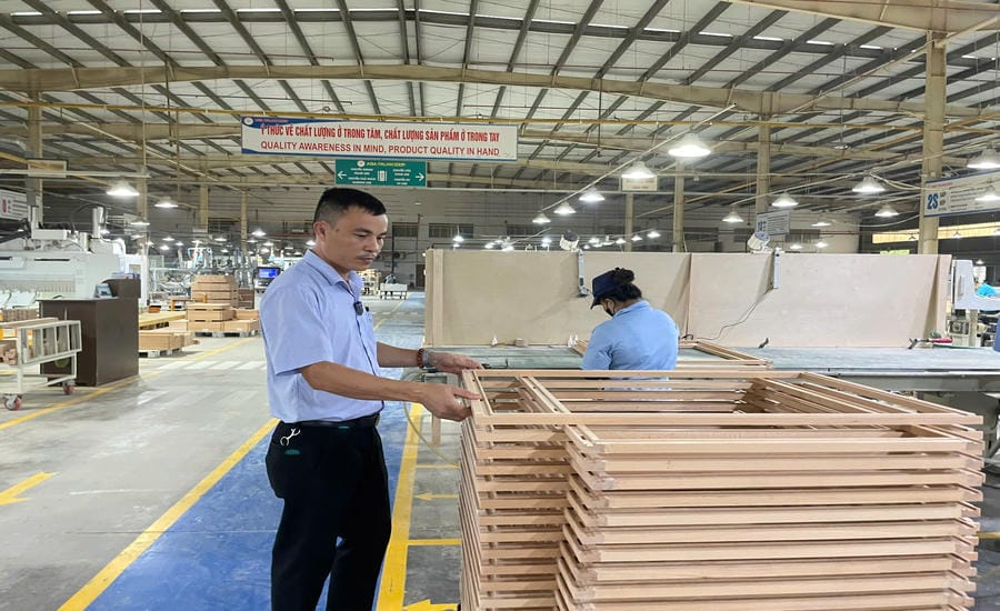 Giám đốc Nhân sự Công ty TNHH Kỹ nghệ Cửa Ý Á Châu Đào Quang Thọ kiểm tra sản phẩm. Ảnh: Đình Trọng
