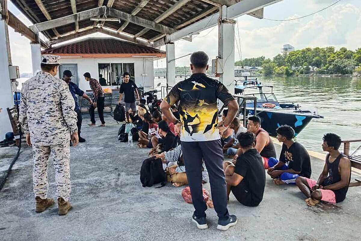 Malaysian authorities check people rescued after a shipwreck carrying migrants. Photo: AFP