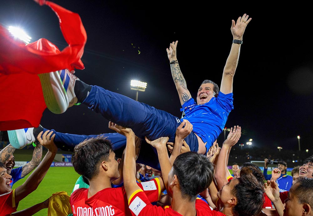Les joueurs vietnamiens U17 et l'entraîneur Roland célèbrent après avoir remporté leur billet pour la Coupe du Monde FIFA U17 2026. Photo: VFF