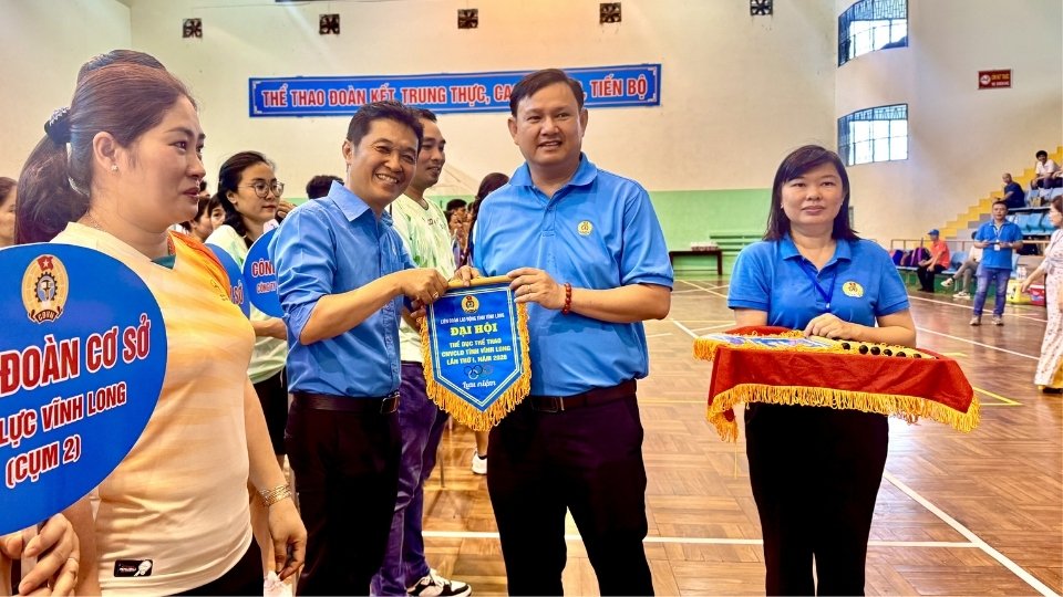 Ông Nguyễn Phúc Linh - Chủ tịch LĐLĐ tỉnh Vĩnh Long trao cờ lưu niệm cho các đoàn tham gia Đại hội Thể dục thể thao công nhân viên chức lao động tỉnh Vĩnh Long. Ảnh: Hoàng Lộc