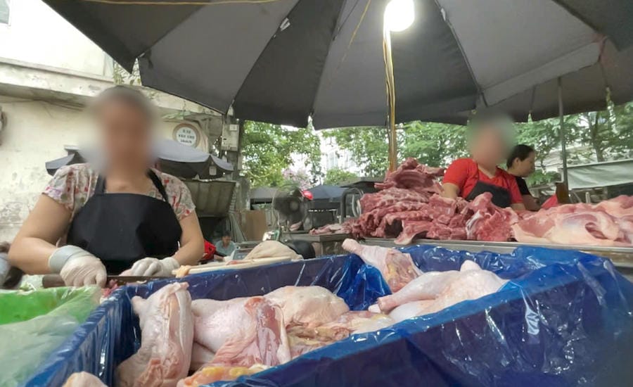 Boxes of frozen chicken meat are displayed right in hot, watery weather. Photo: Hoang Xuyen