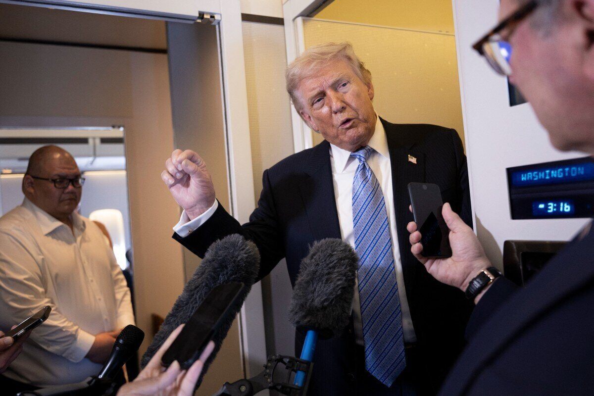 President Trump talks to reporters on Air Force One after a visit to Beijing. Photo: AFP
