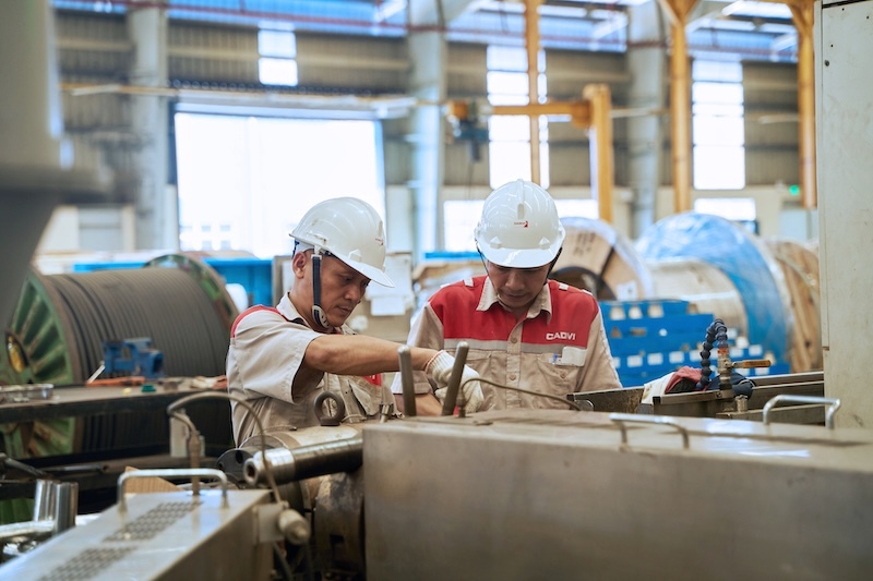 Three major pillars including green transformation, digital transformation and ESG practice have been identified by businesses as a new development strategy to enhance global competitiveness. Pictured are workers producing electrical equipment in a factory. Photo: DNCC