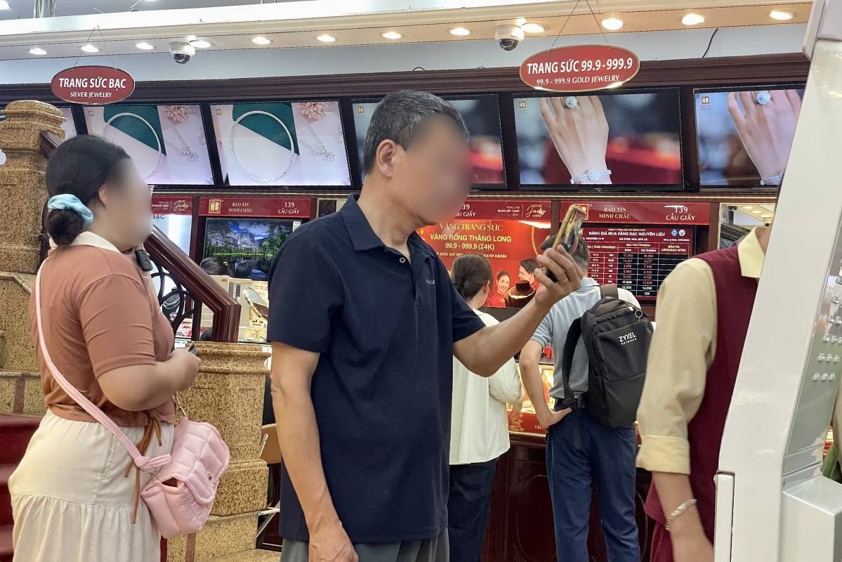 Người dân xếp hàng chờ giao dịch tại máy thanh toán tự động. Ảnh: Hạ Linh