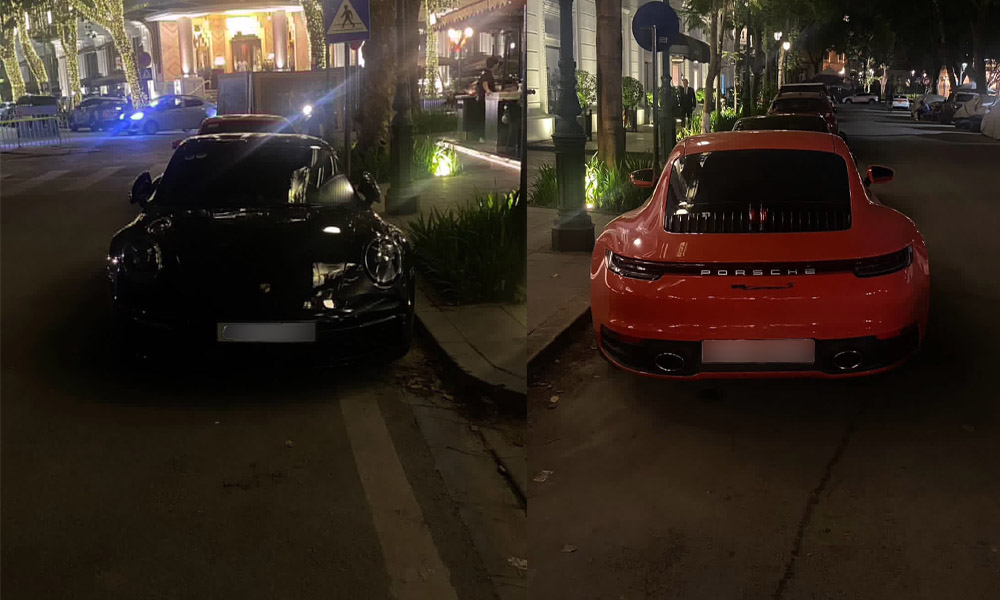 Two Porsche 911 stand out when appearing on the streets of Hanoi with contrasting black and orange exteriors. Photo: Nguyen Hieu