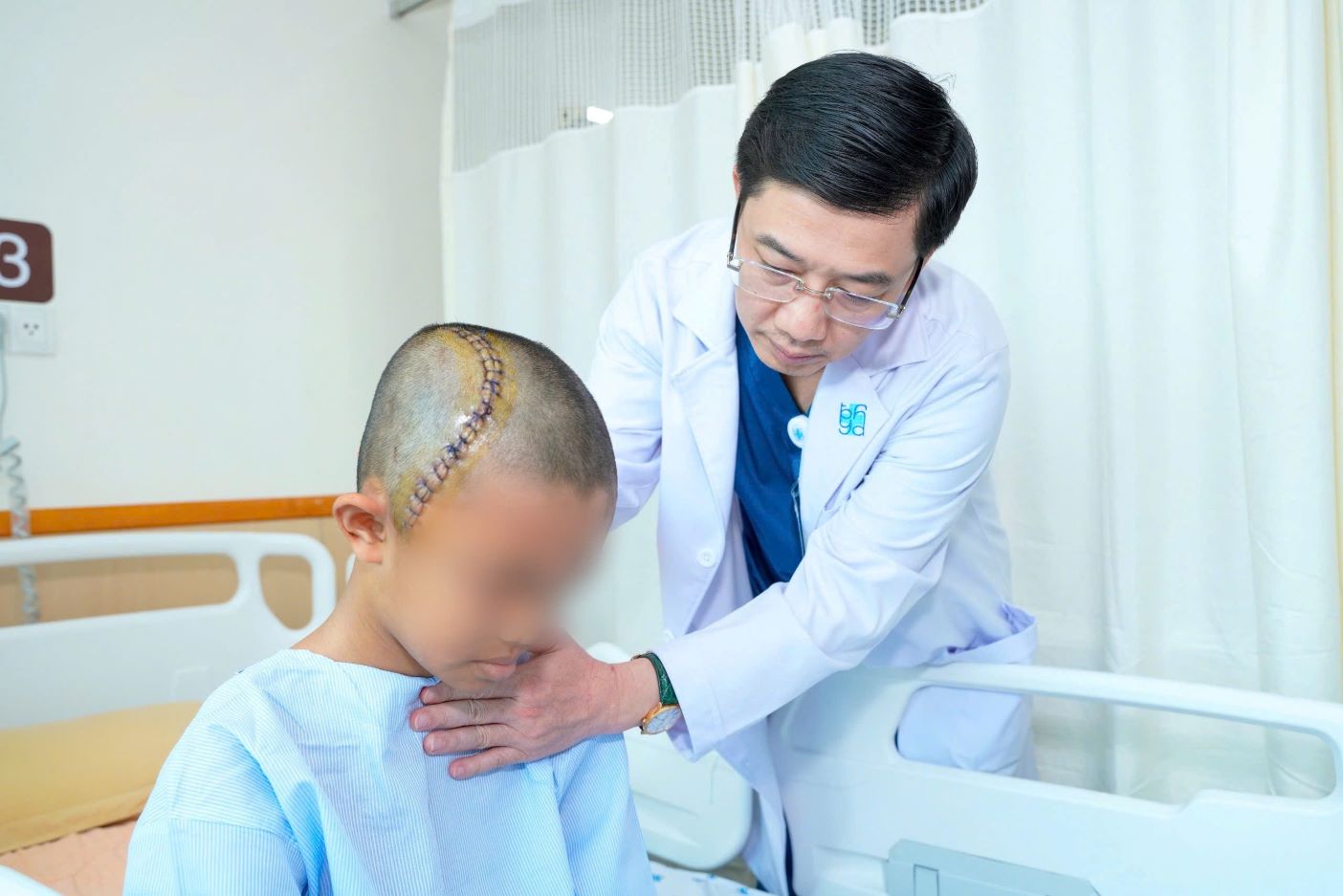Doctors examine a child patient after a provincial skull surgery. Photo: Hospital provided
