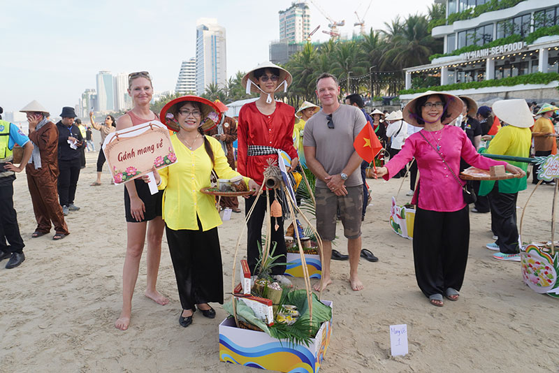 Du khách check-in cùng đoàn gánh hàng rong tại Đà Nẵng Food Tour 2026. Ảnh: Trần Thi