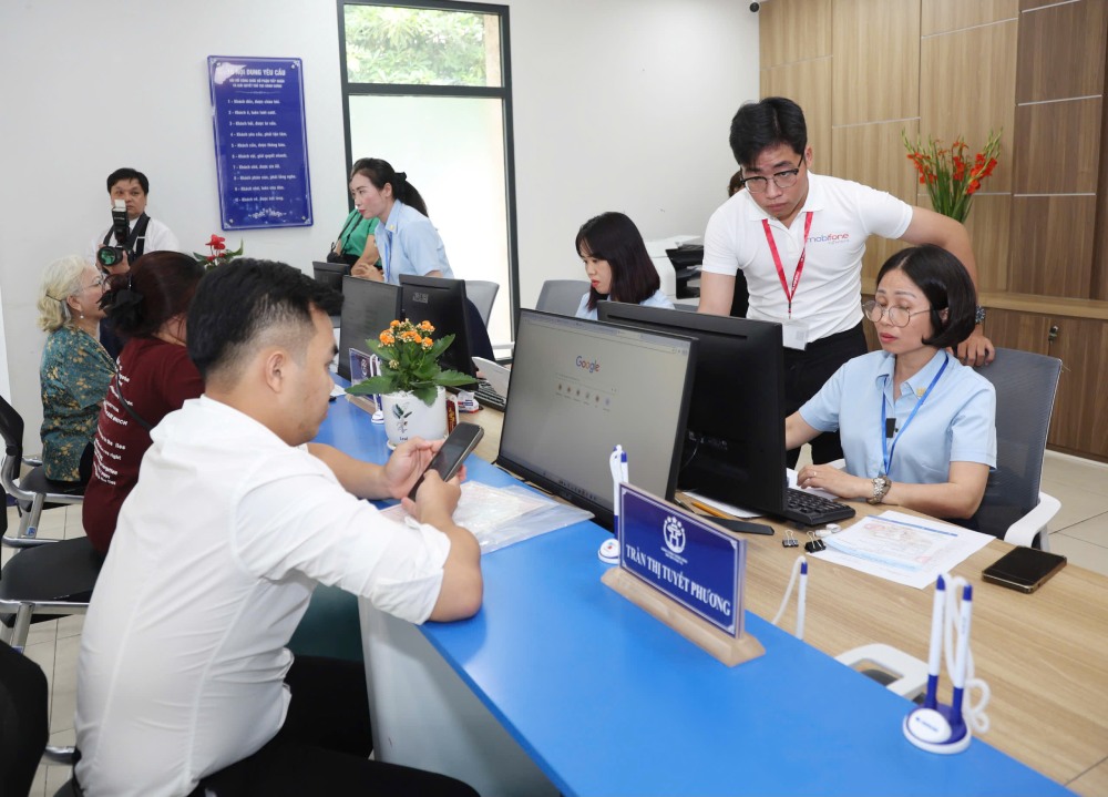 Hanoi will receive 230 quotas of non-specialized commune-level personnel to become civil servants. In the photo, officials handling administrative procedures for people in Tay Ho ward, Hanoi. Photo: Pham Dong