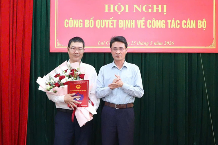 El vicepresidente del Comité Popular Provincial, Hà Trọng Hải (a la derecha de la foto), entrega la decisión y entrega flores para felicitar al Sr. Nguyễn Phương Hạnh. Foto: Comité Popular Provincial de Lai Châu
