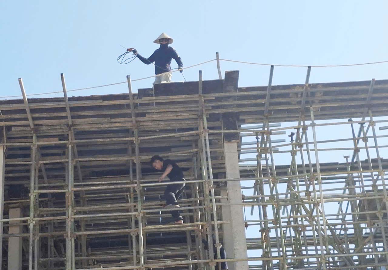 Công nhân thi công phần giàn giáo khá vất vả vì nắng nóng. Ảnh: Trần Tuấn