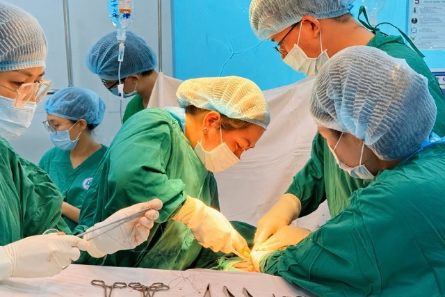 Doctors operate on a patient with uterine fibroids causing abdominal compression. Photo: BVCC