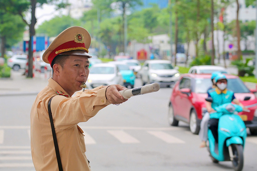 Lực lượng CSGT túc trực tại các nút giao trọng điểm để điều tiết giao thông. Ảnh: Tô Thế