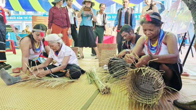 Nghệ nhân người Cor trình diễn đấu chiêng (ảnh trên) và nghề đan lát truyền thống (ảnh dưới), phục vụ công chúng tại triển lãm. Ảnh: Hoàng Bin