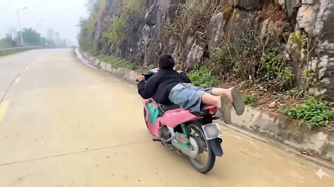 Young man lying face down on the saddle while driving a motorbike. Photo: Traffic Police Department