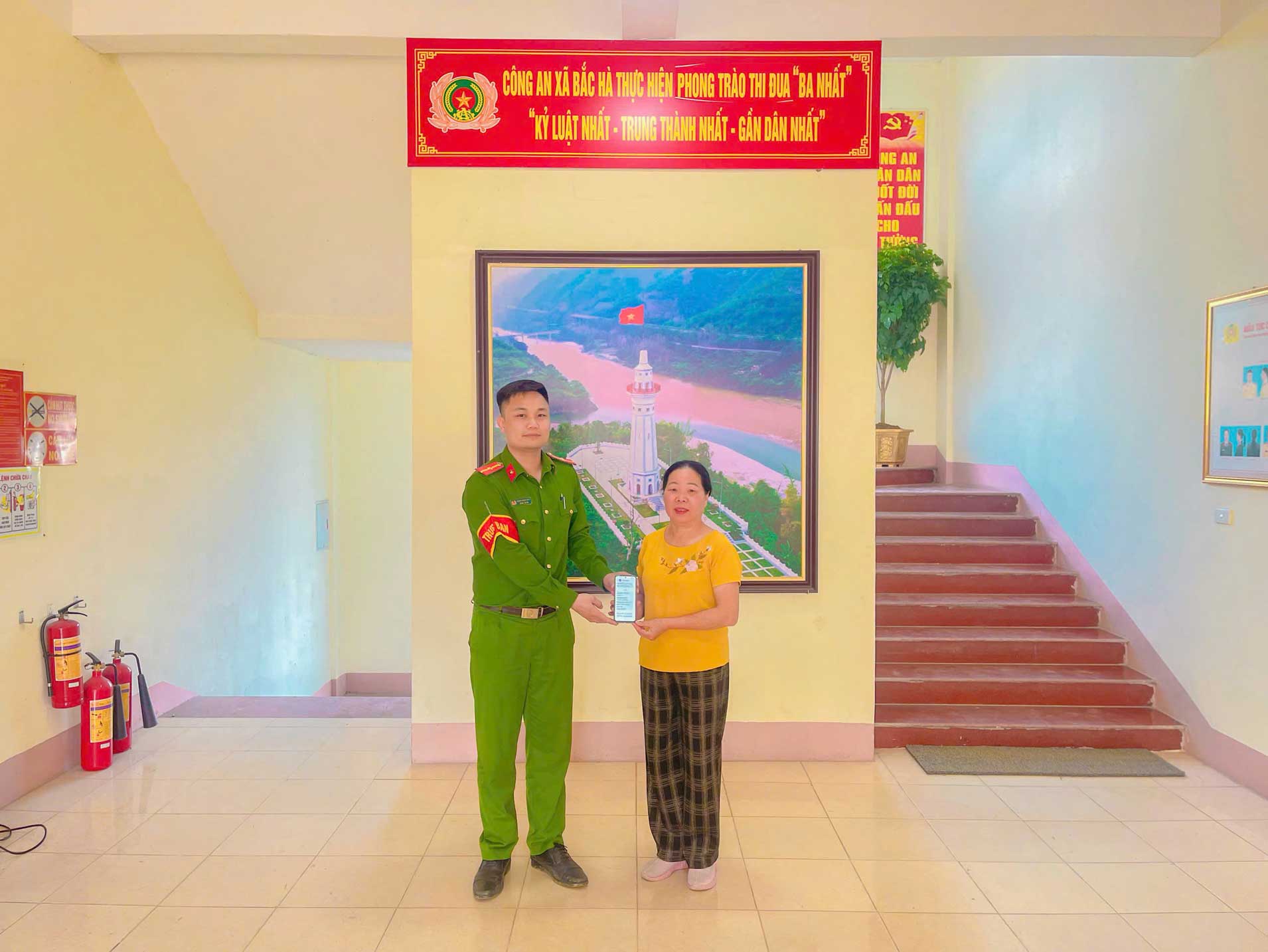 Công an xã Bắc Hà hướng dẫn người dân chuyển khoản cho chủ sở hữu. Ảnh: Công an Lào Cai