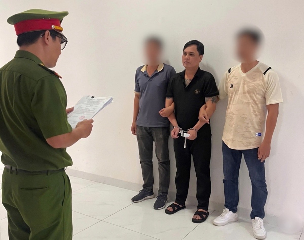 Công an đọc lệnh bắt tạm giam bị can sau khi triệt phá đường dây môi giới mại dâm trực tuyến. Ảnh: Công an 