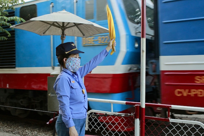 Les gardes-barrière mettent en place des avertissements de sécurité lorsque les trains passent. Photo: Ngoc Bich
