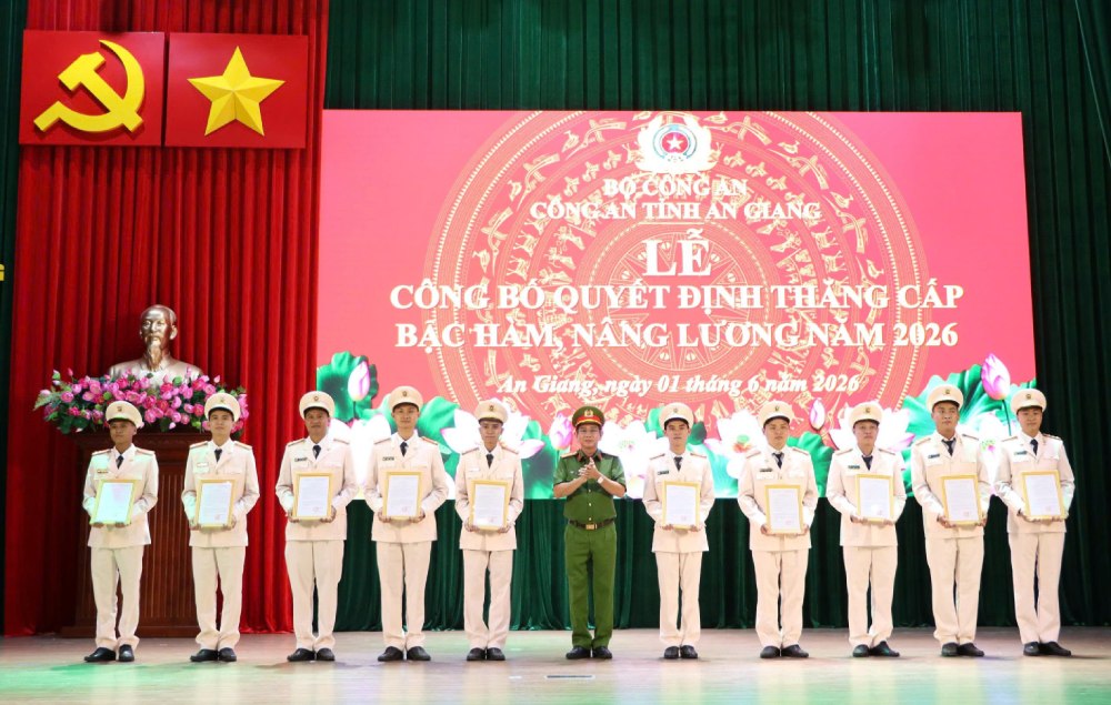 Đại tá Trần Văn Cung, Phó Giám đốc Công an tỉnh An Giang trao Quyết định cho các đồng chí được thăng cấp bậc hàm, lên lương năm 2026. Ảnh: Tiến Dũng