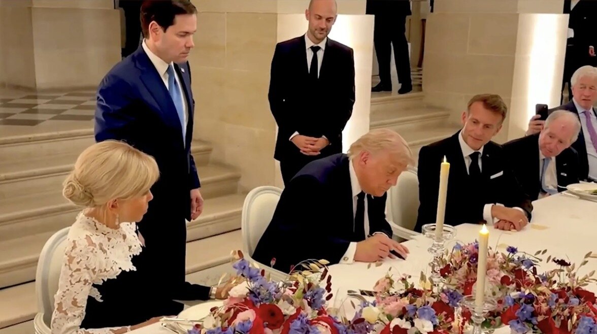 President Donald Trump signs a memorandum of understanding on peace between the US and Iran at the Palace of Versailles, near Paris. Photo cut from video White House/X
