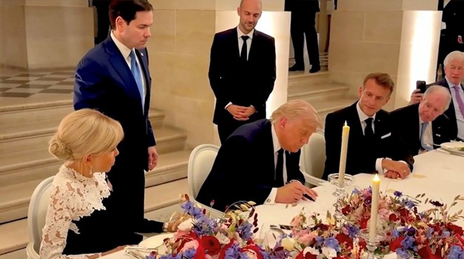 President Donald Trump signs a memorandum of understanding on peace between the US and Iran at the Palace of Versailles, near Paris. Photo cut from video White House/X