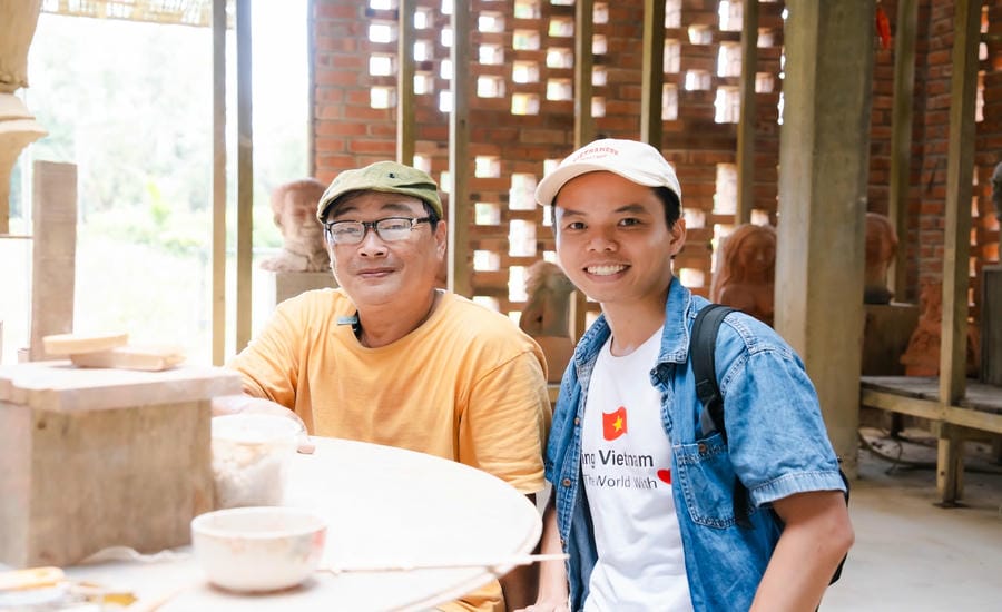 Tran Viet Anh (right) on a trip to learn about Champa terracotta. Photo: Character provided