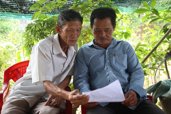 Ông Hồ Hữu Thành (bên phải ảnh) cùng người dân ở xã Vĩnh Thủy phát hiện số tiền hỗ trợ thiên tai nhận được thấp hơn so với phê duyệt của UBND tỉnh Quảng Trị. Ảnh: Hưng Thơ