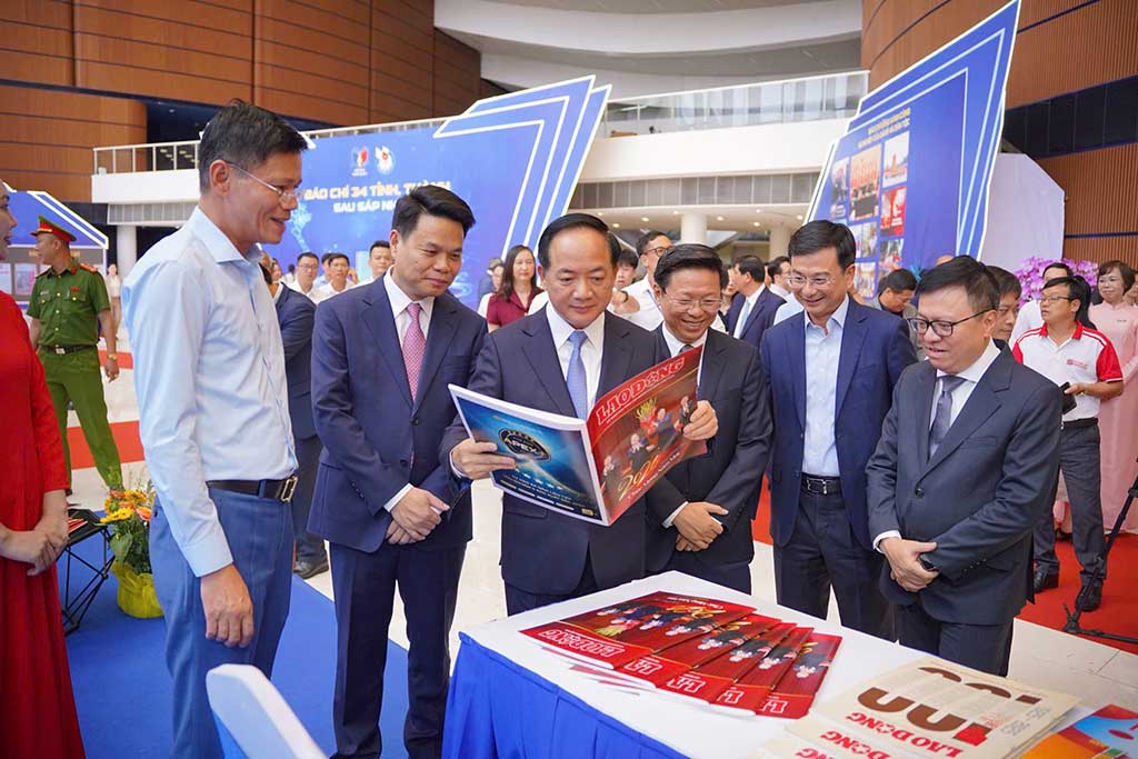 Comrade Trinh Van Quyet - Member of the Politburo, Secretary of the Party Central Committee, Head of the Central Propaganda and Mass Mobilization Commission and delegates at the booth of Lao Dong Newspaper at the National Press Festival 2026. Photo: Mai Dung