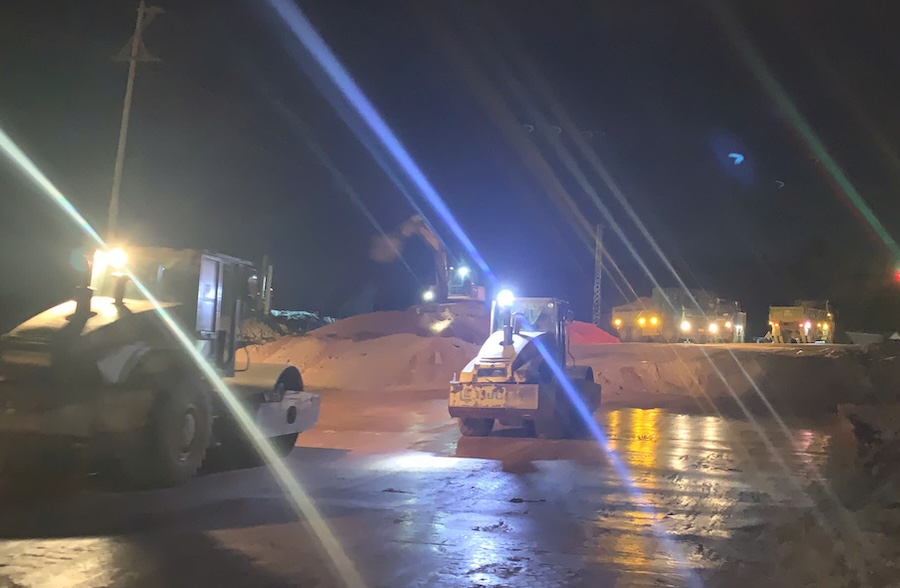 Workers constructing the final items at the intersection of the Dong Ha bypass project at night. Photo: Han Nguyen